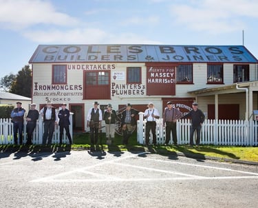 Volunteers in period costume standing in front of the restored Coles Joinery Factory