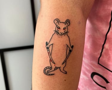 a mouse tattoo on the arm of a man made at Inari Tattoo