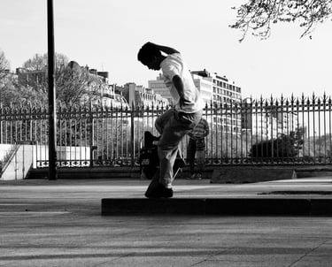 a man riding a skateboard on a sidewalk