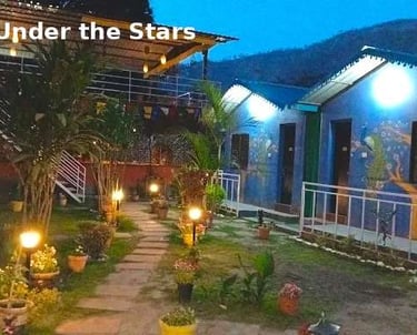  Night view of Jungle Lore Resort luxury cottages with garden lights