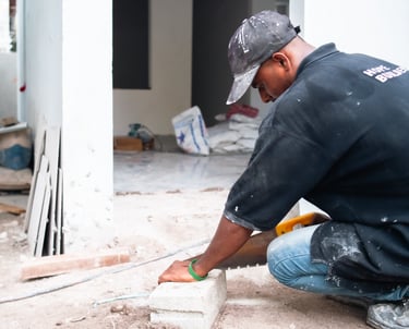 a man in a black shirt engaged in construction work