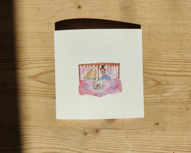 a queer greetings card of a queer couple in bed watching tv on a laptop.