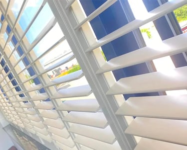 Hard wood shutters fitted in a sunny window