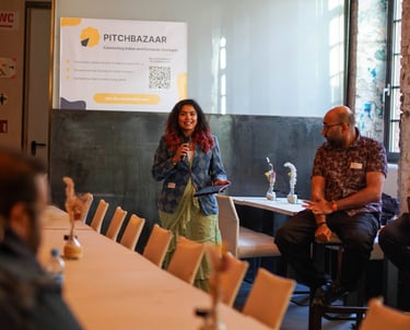 Shruti the founder, moderating the Pitchbazaar event with a mic in her hand.
