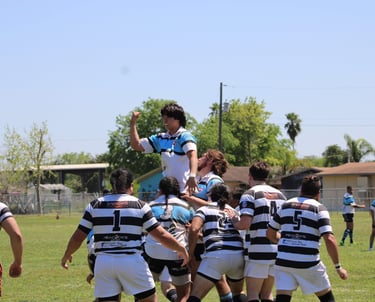 a group of men playing rugby in a field