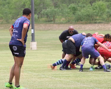 a group of men playing rugby in a field