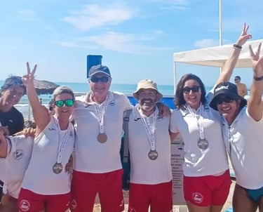 a group of people standing around a beach