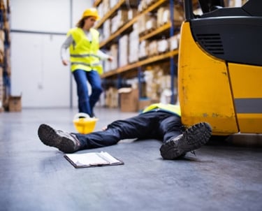 a man laying on the floor in a warehouse