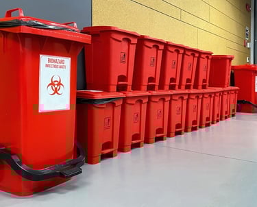 a bunch of red bins with biohazard signs