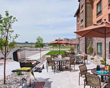 a patio with a grill and a grill