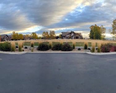 a street corner with a house in the background