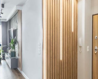 a hallway with a wooden paneled wall and a wooden door