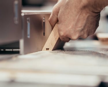 Mann sägt einen Winkel in ein Stück Eichenholz