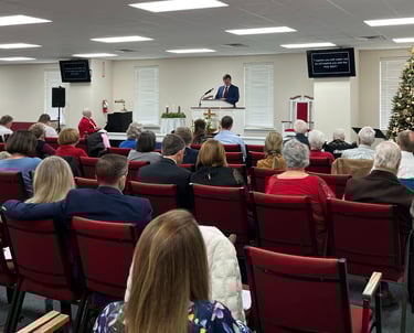 People sitting in chairs during a church service
