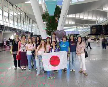 a group of young people standing in a lounge or Wroclaw airport