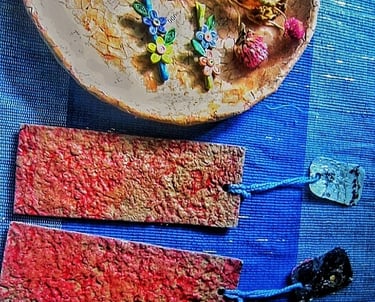 Recycle paper texture red plain color bookmark  with recycle paper flower quilling hair clips on the plate 