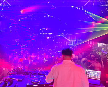 a dj spinning around in a nightclub