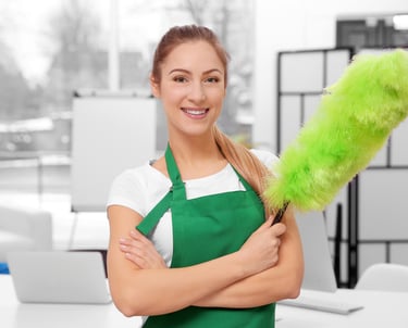 a woman in green aprons holding a green duster