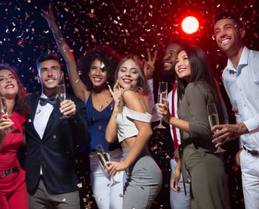 Group of friends enjoying a VIP nightclub crawl in Las Vegas with champagne and confetti.