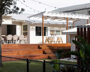 a house with a deck and a deck with chairs