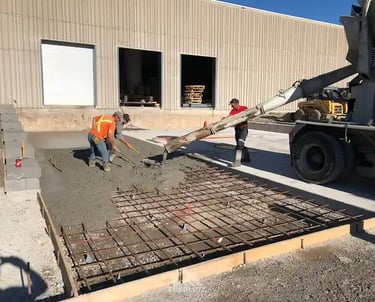 a man is pouring concrete into a concrete slab
