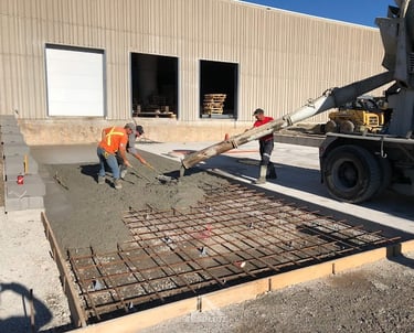 a man is pouring concrete into a concrete slab