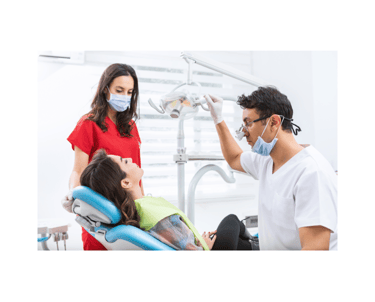 Dentist and assistant treating a patient in a modern dental clinic. Professional dental care in Turkey with expert consultati