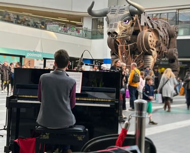 David Rice playing piano at Birmingham New Street Station