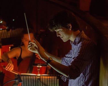 David Rice conducting in an orchestra pit