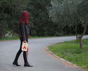 woman holding wooden bag shaped like gas can