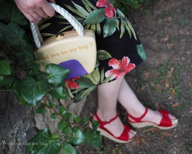 a woman in a dress with a wooden pin-up handbag