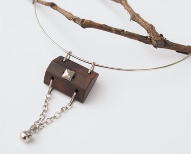 Necklace with wooden pendant decorated with stud and chains