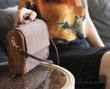 Woman holding wooden bag made from exotic zebrano wood