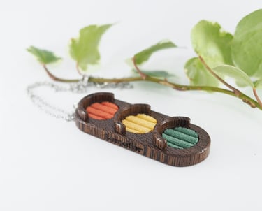 wooden pendant in a shape of traffic light with red, yellow and green corduroy inserts