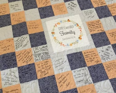 Wedding guest book quilt signing station with fabric squares and fabric pens