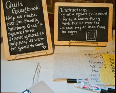 Wedding guests signing fabric squares for a signature quilt guest book
