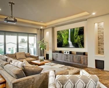 Modern home theater with a custom projection screen and ceiling-mounted projector.