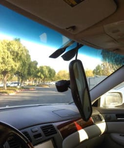 a car with a mirror and a mirror in the back ground