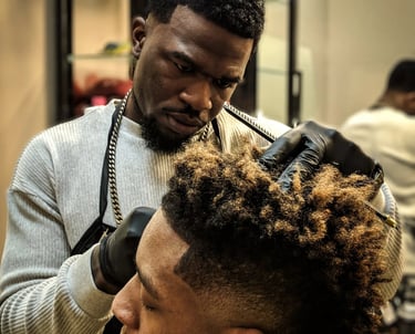 a man getting his hair cut off by a barber