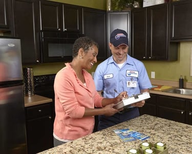 Roto-Rooter Technician Collecting Signature For Service Order