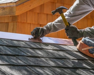 roofer hammering in nails