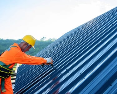 worker wearing protective equipment installing a metal roof