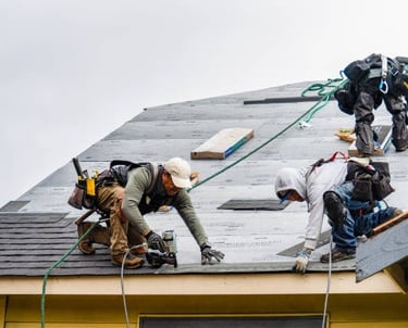 workers installing new roof tiles