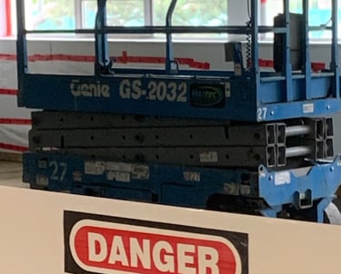 Scissor lift with a Danger Banner Guard across it