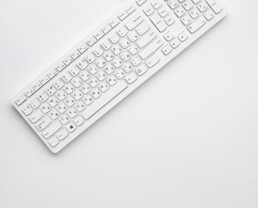 white corded computer keyboard on white surface