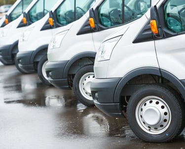 a row of parked delivery vans