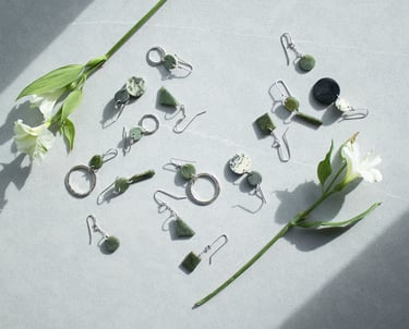 handmade pounamu earrings laid out on a table