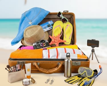 Must have travel essentials and packing accessories neatly arranged in luggage