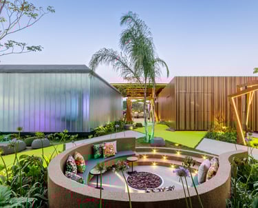 Modern outdoor lounge with a sunken circular fire pit, stylish patio furniture, and architectural landscaping.