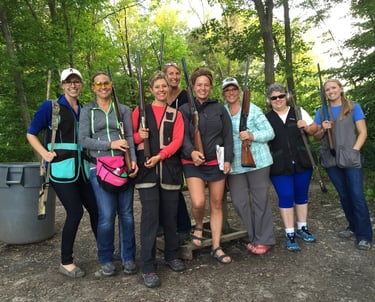 Group of women holding shotguns on sporting clays course.